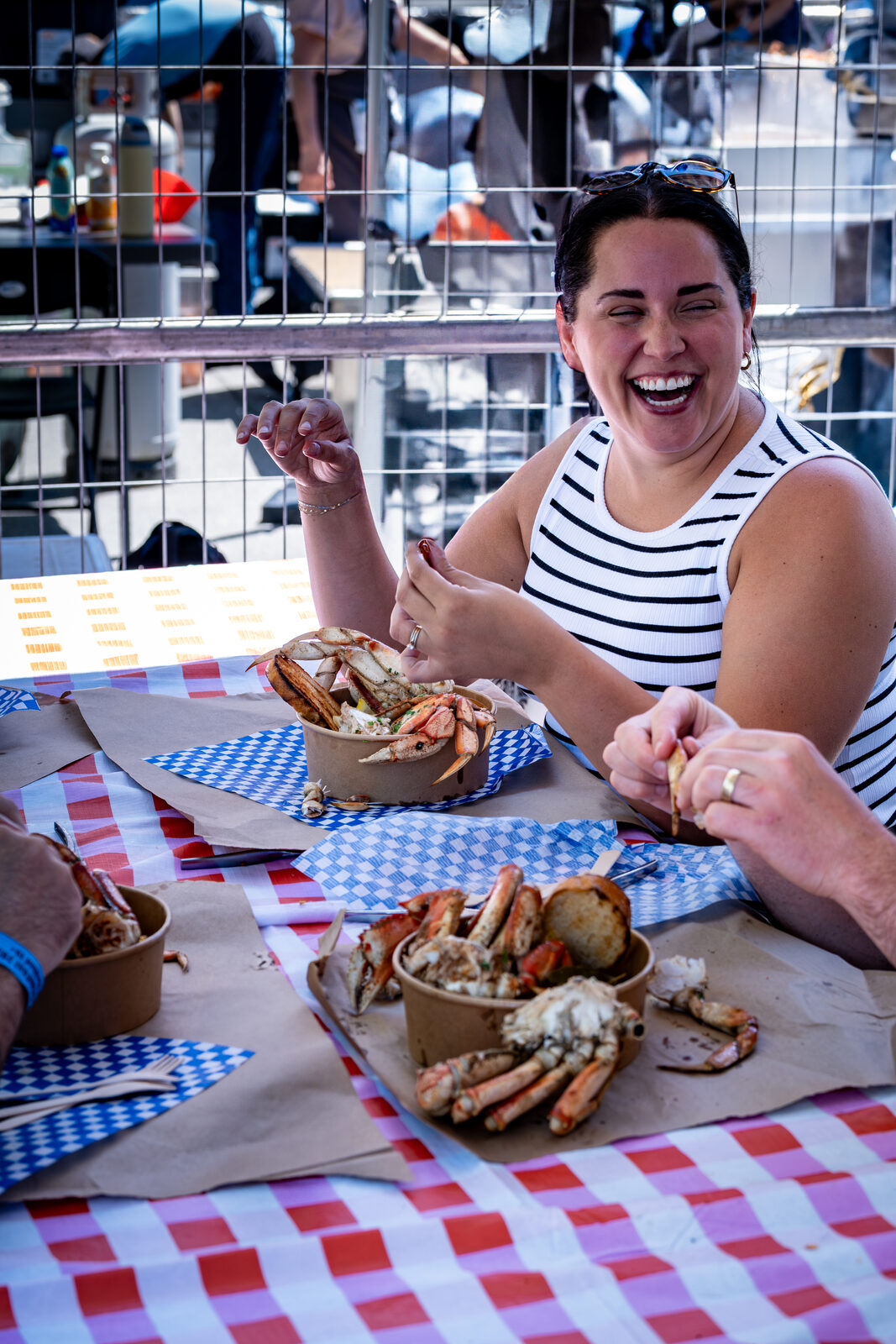 Guest laughing while enjoying the BC Crab Boil at CrabFest